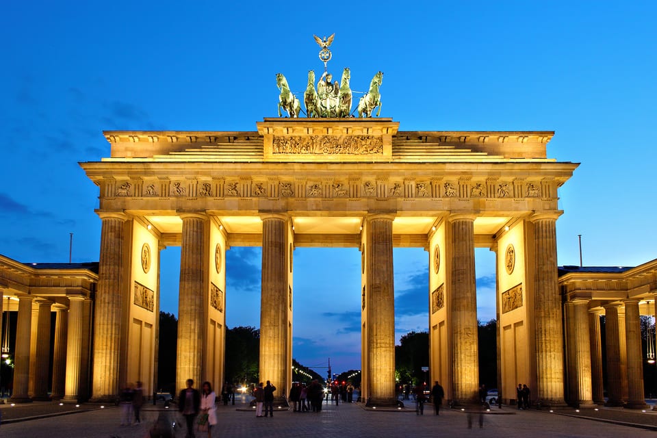The Brandenburg Gate illuminated in the evening.